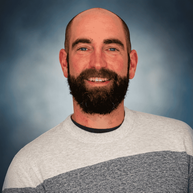 Zach White, LCPC smiling at Interpersonal Psychiatry clinic.