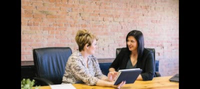 Therapist and patient discussing mental health assessment in office.