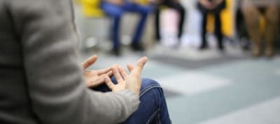 Group therapy session with participants sharing experiences and support.