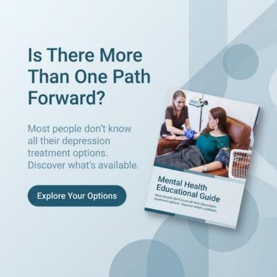 Mental health professional administering TMS to patient in a clinical setting.