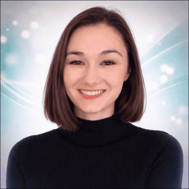 Smiling young woman with shoulder-length brown hair, wearing a black turtleneck, in a bright, calmin.
