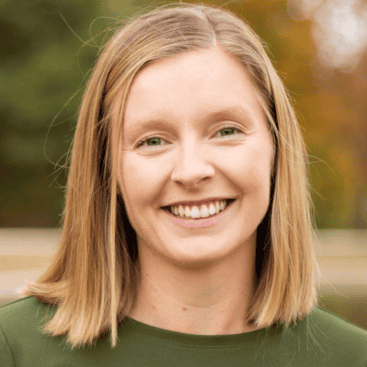 Lindsey Costello smiling outdoors at Interpersonal Psychiatry clinic.